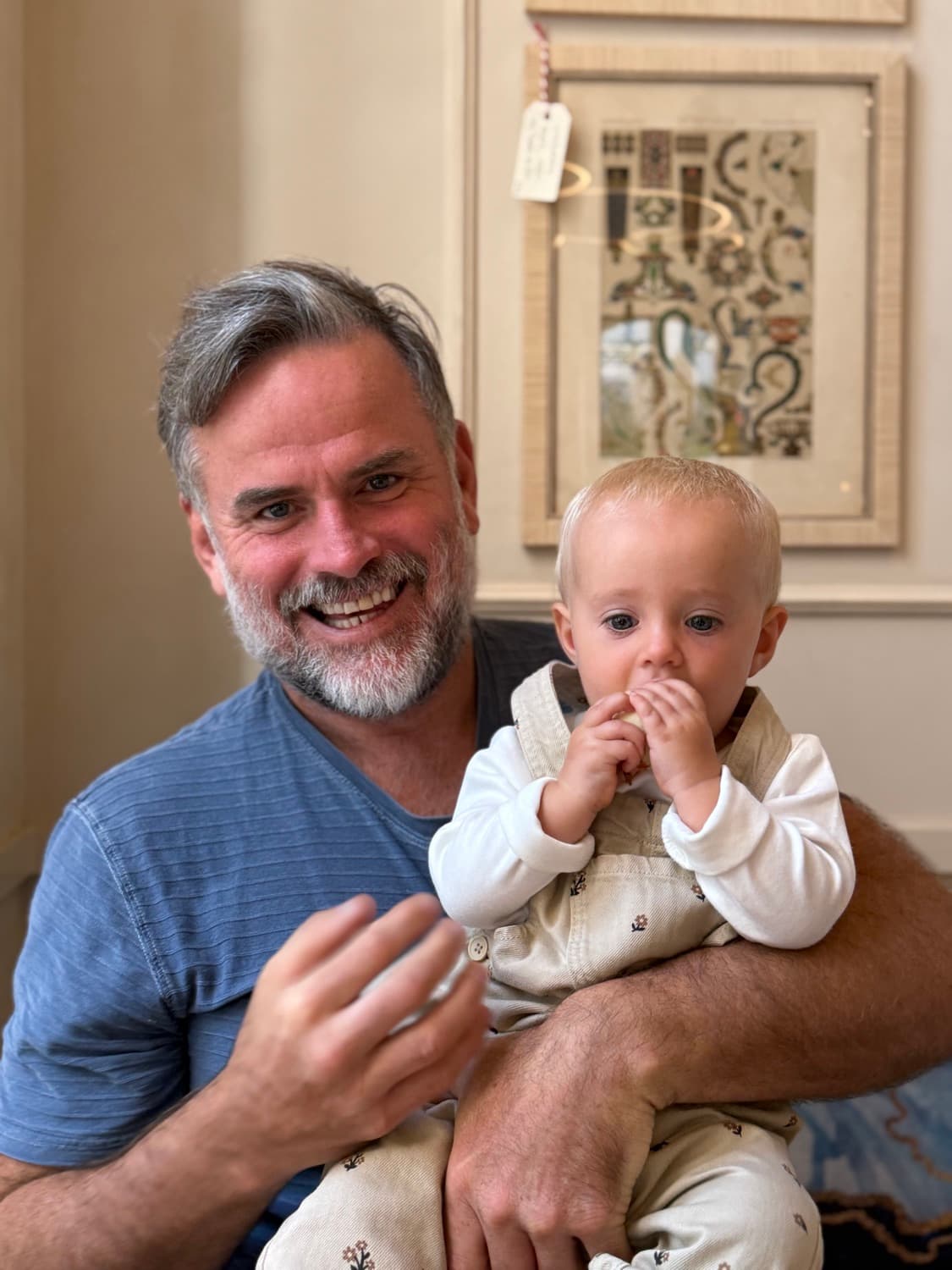 Shane Williams holding his young son in a café